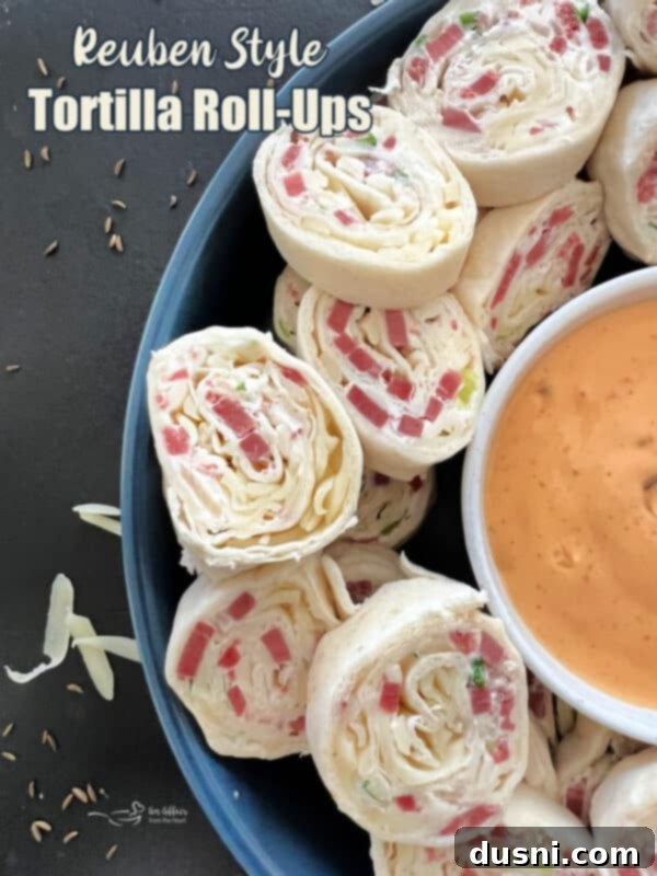 Reuben Style Tortilla Roll-Ups arranged attractively on a platter, ready to be served as an appetizer.