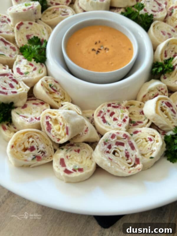 Close-up of Reuben Style Tortilla Roll-Ups arranged on a platter, ready for serving as a delicious party appetizer.