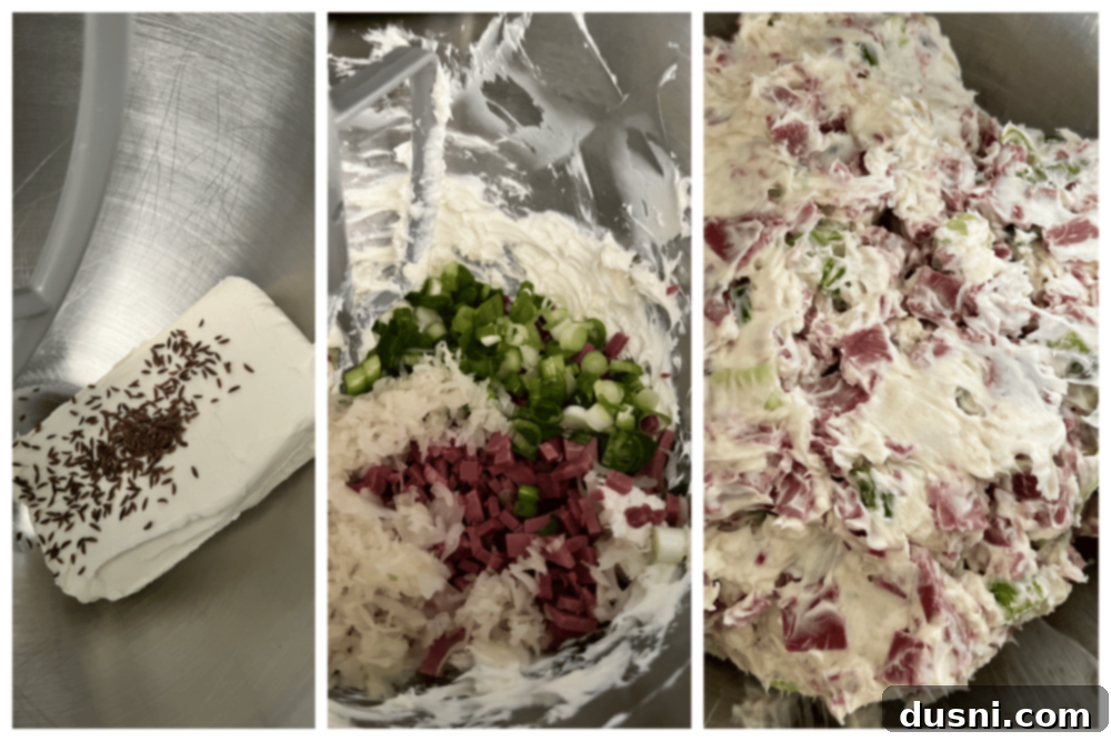 Step-by-step image showing cream cheese and caraway seeds being whipped together in a stand mixer bowl for Reuben Style Tortilla Roll-Ups.