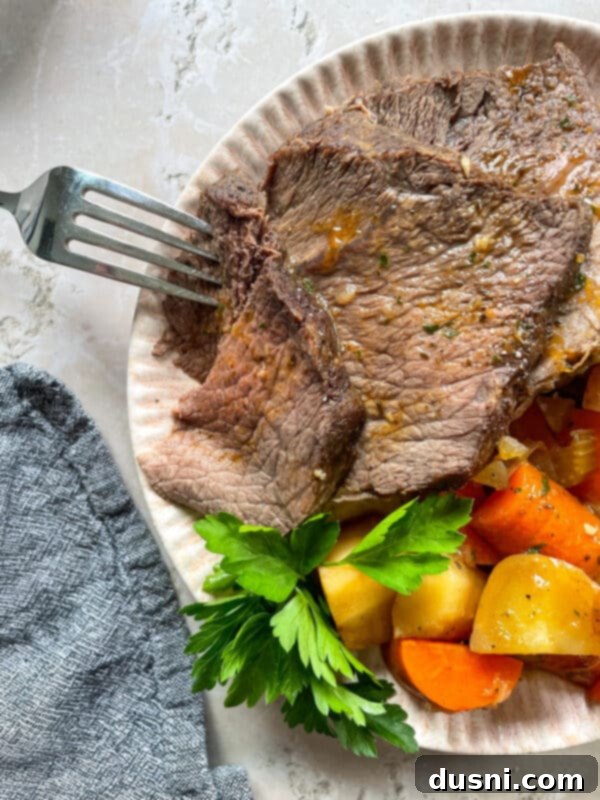 Homemade Bob Evans Style Pot Roast 2 Copycat Bob Evans Pot Roast served on a plate with vegetables and gravy.