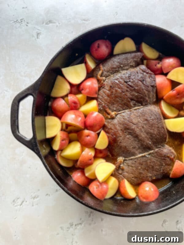 Homemade Bob Evans Style Pot Roast 11 Returning browned roast to the Dutch oven with vegetables and liquid.