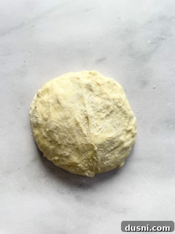 Artisan Pizza Base 6 Salt and the activated yeast mixture being added to the rested dough.