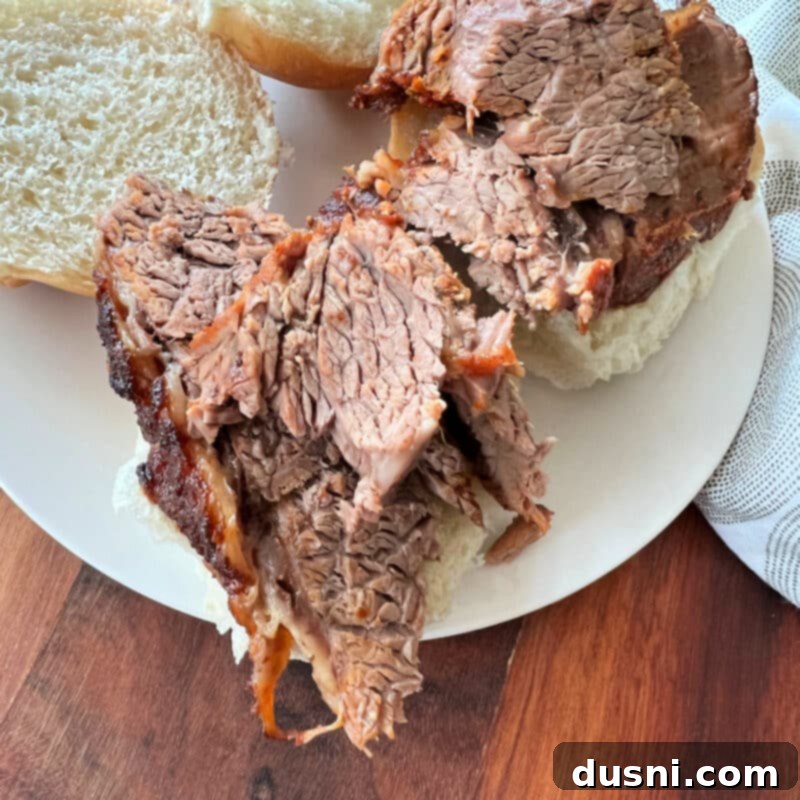 Texas Heat Smoked Brisket 13 Sliced spicy beef brisket placed on a slider roll with horseradish sauce.