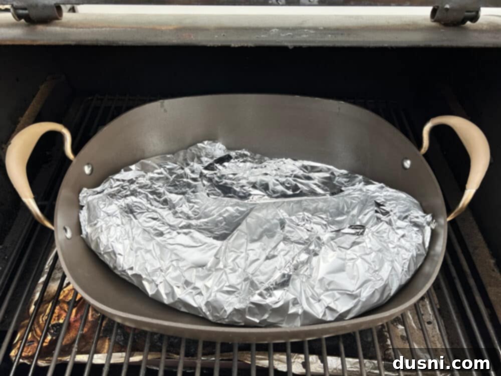Texas Heat Smoked Brisket 10 Smoker with a roaster inside, beginning to smoke the brisket.