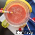 fiber smoothie, banana and straws on blue and white napkins.