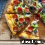 Supreme pizza slices arranged on a rustic wooden board, ready to be enjoyed.