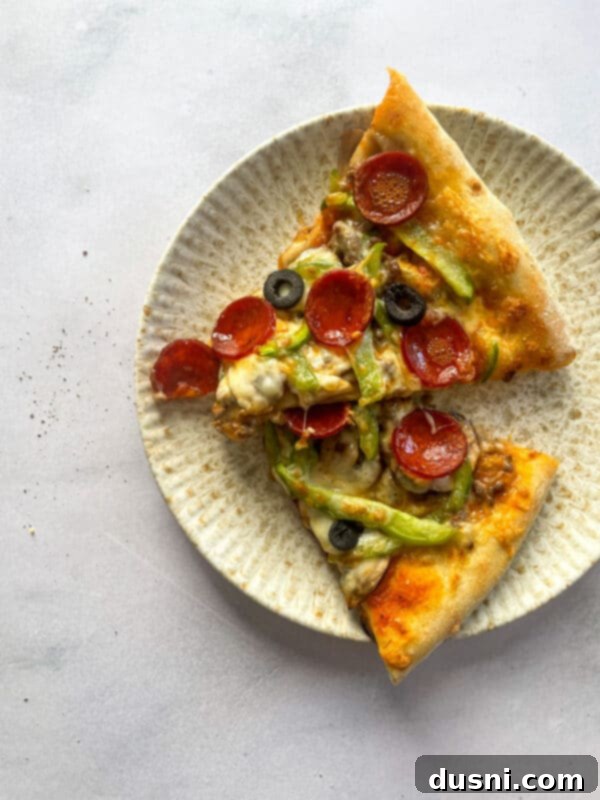 Close-up of Supreme Pizza ingredients laid out on a cutting board, including pepperoni, olives, and peppers.