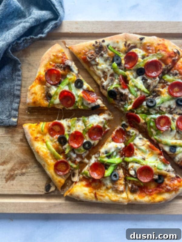 A delicious homemade Supreme Pizza, freshly baked and glistening with melted cheese and toppings.