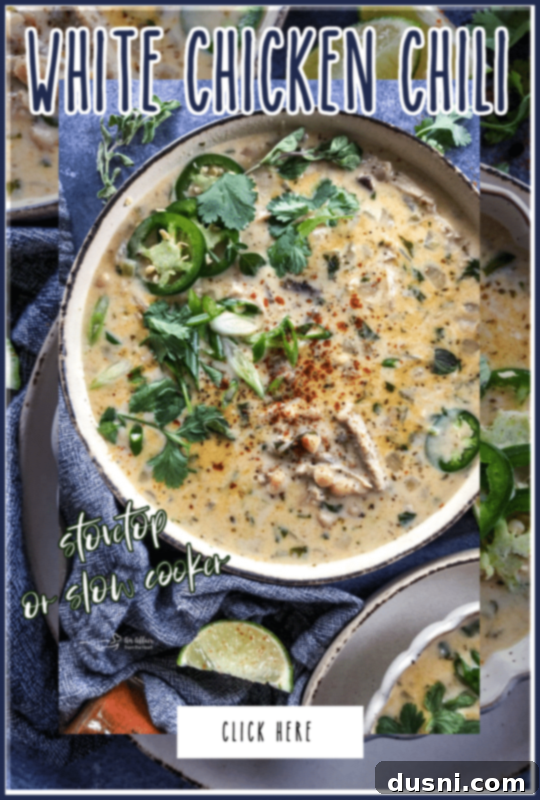 Creamy White Chicken Chili 3 A top-down view of a spoonful of creamy white chicken chili, showcasing the beans, chicken, and green chiles.
