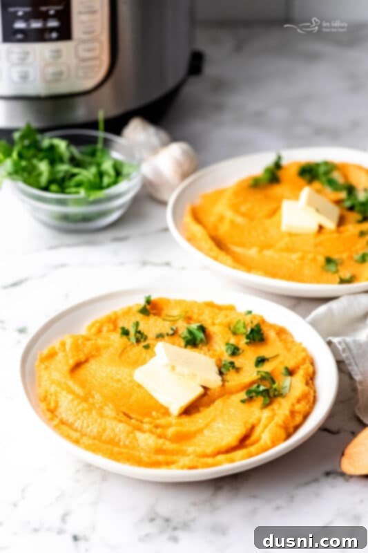 Instant Pot Sweet Potato Mash garnished with rosemary sprigs