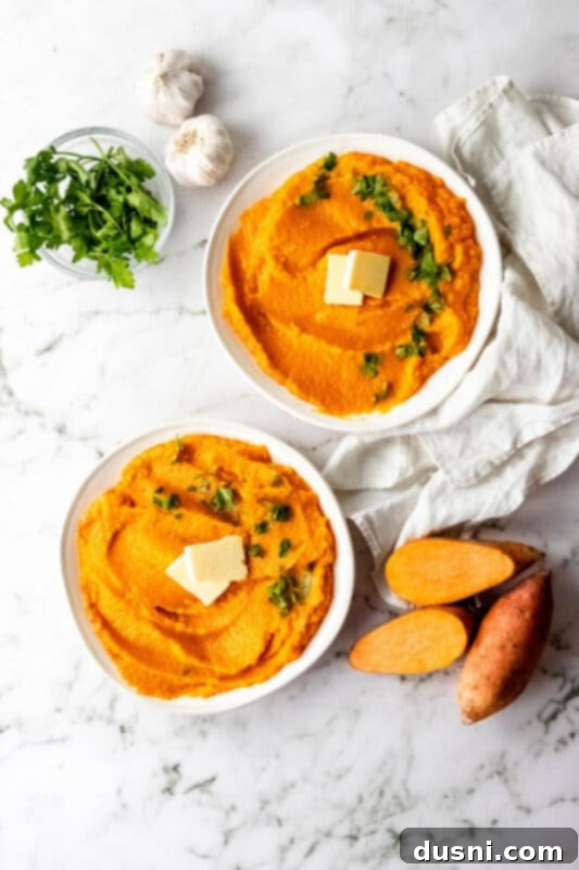 Two bowls of Instant Pot Mashed Sweet Potatoes with parsley