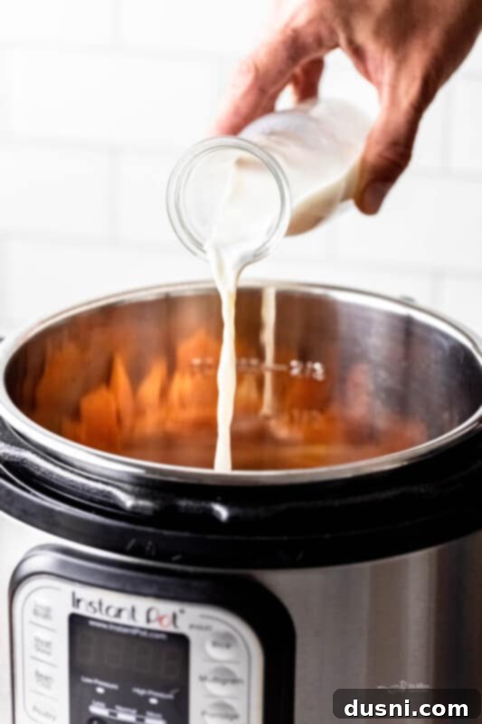 Close-up of mashed sweet potatoes being stirred
