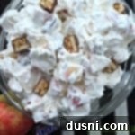 Decadent Snickers Apple Salad 15 Close up of snicker apple salad in a clear bowl