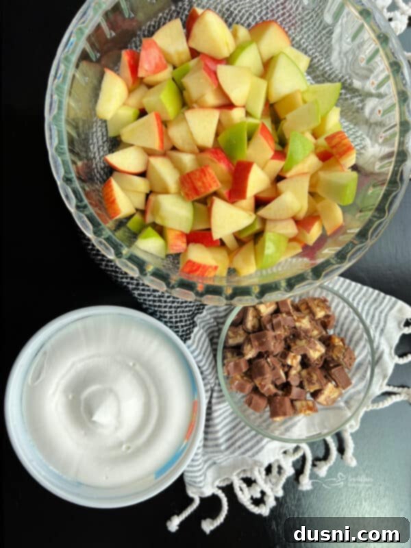 Decadent Snickers Apple Salad 6 Snicker Apple Salad presented in a clear glass bowl