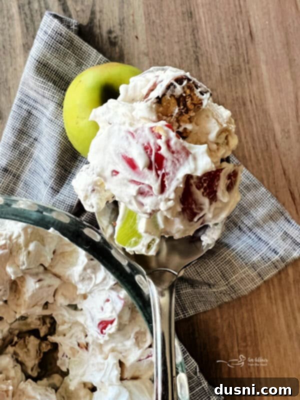 Decadent Snickers Apple Salad 7 Closeup of the three main ingredients for Snicker Apple Salad: diced apples, Cool Whip, and chopped Snickers bars