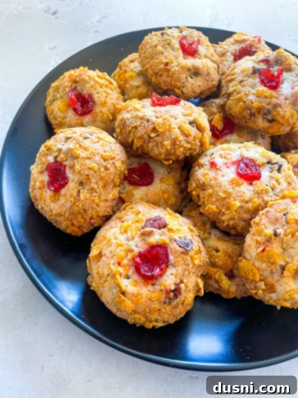 Close-up of baked Cherry Wink Cookies, showcasing their golden crust and cherry topping.
