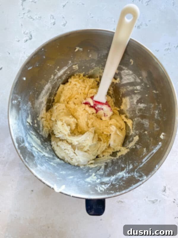 Mixing sugar and shortening for Cherry Wink Cookies.