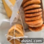Orange ginger refrigerator cookies layered in a decorative box and tied with a string.