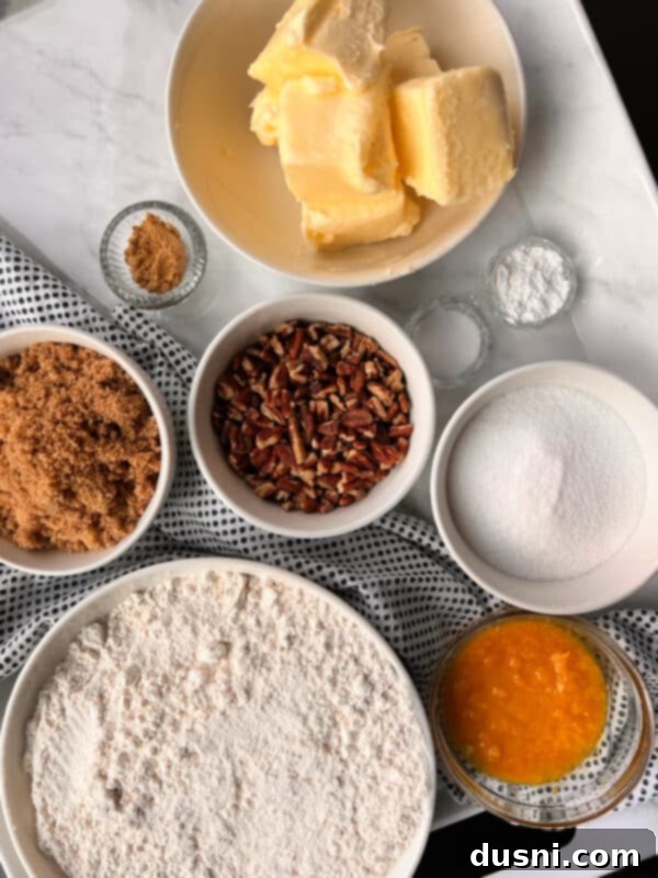 Stacked Orange Ginger Refrigerator Cookies on a white plate with orange slices.