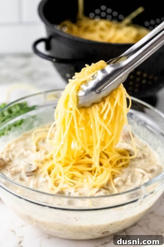 Hearty Leftover Turkey Pasta Bake 7 The creamy sauce for Turkey Pasta Bake, perfectly mixed in a large bowl, ready for the next step.