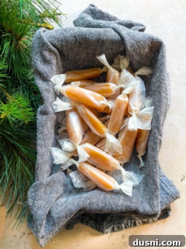 A close-up shot of unwrapped homemade caramels, showcasing their golden-brown color and soft texture.