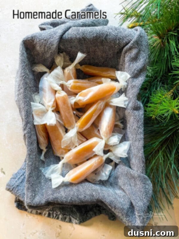 A large stack of individually wrapped homemade caramels, showcasing their attractive golden color.