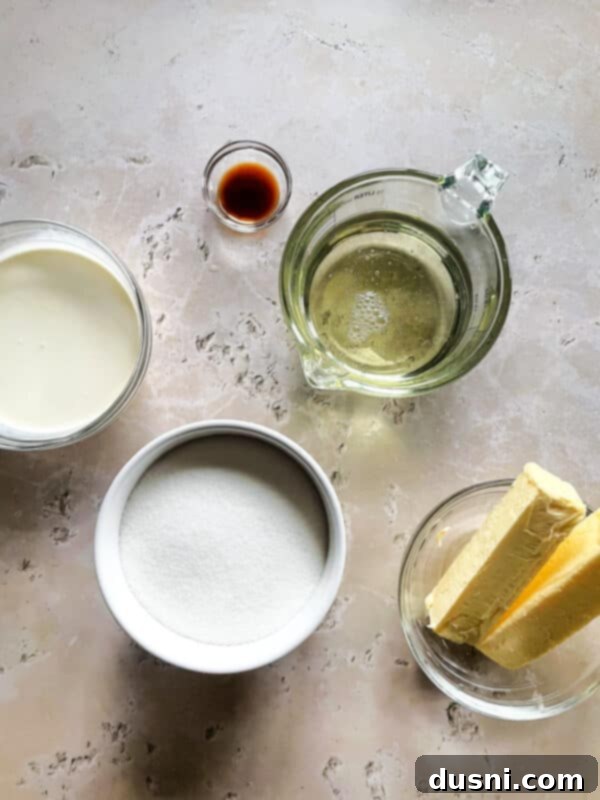 A wooden cutting board piled high with individually wrapped homemade caramels, ready for gifting or enjoying.
