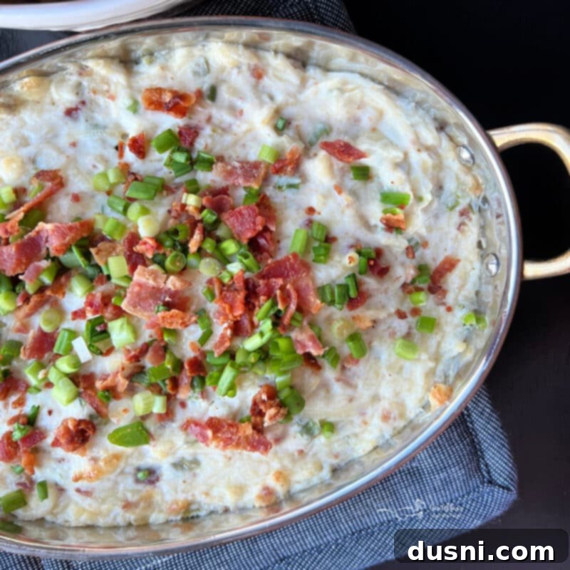 Sauerkraut, Bacon, and Swiss Dip 11 Baked Sauerkraut Bacon & Swiss Dip in a white dish with crackers