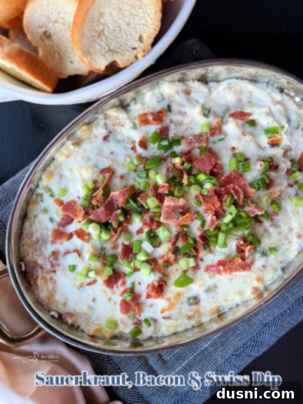Sauerkraut, Bacon, and Swiss Dip 15 Baked Sauerkraut Bacon & Swiss Dip in a dish, ready to be served