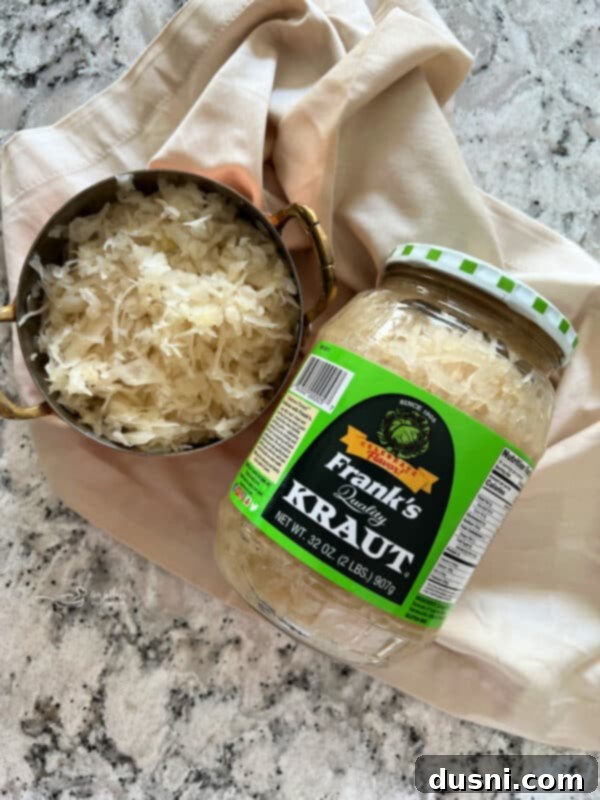 Sauerkraut, Bacon, and Swiss Dip 4 Frank's Kraut jar on a rustic wooden surface