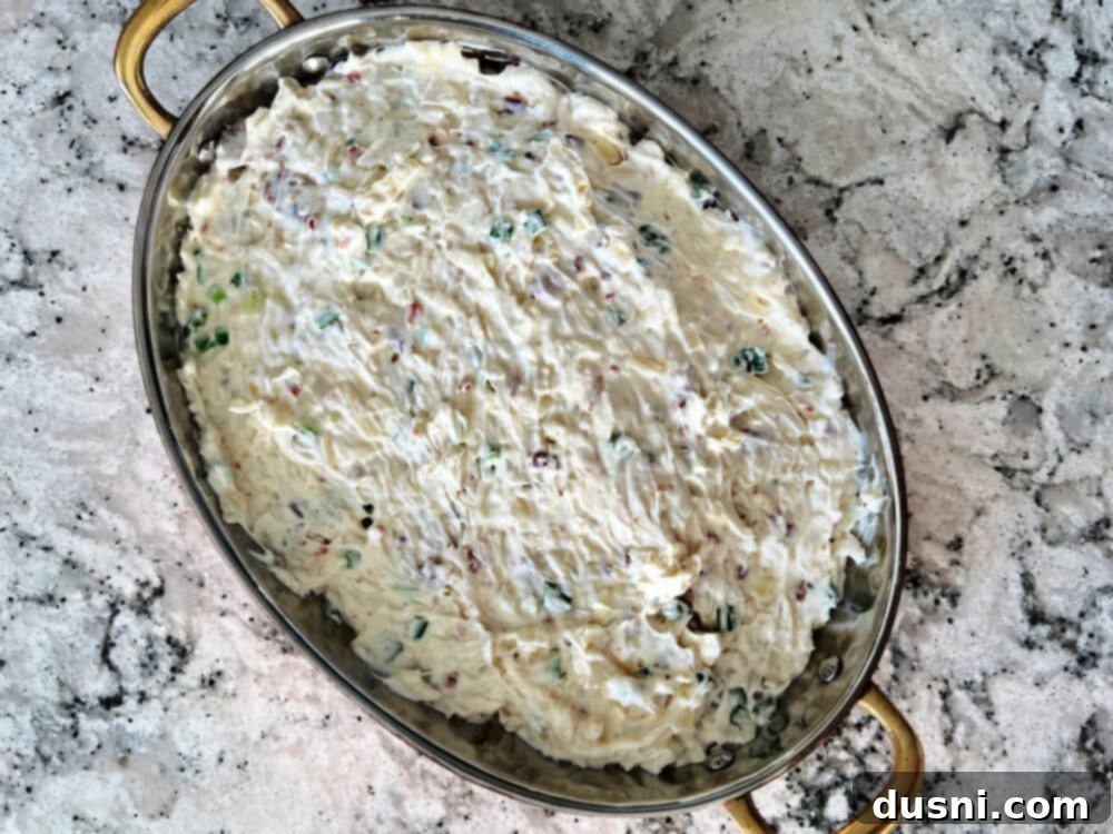 Sauerkraut, Bacon, and Swiss Dip 7 Mixing Sauerkraut, Bacon & Swiss Dip ingredients in a bowl