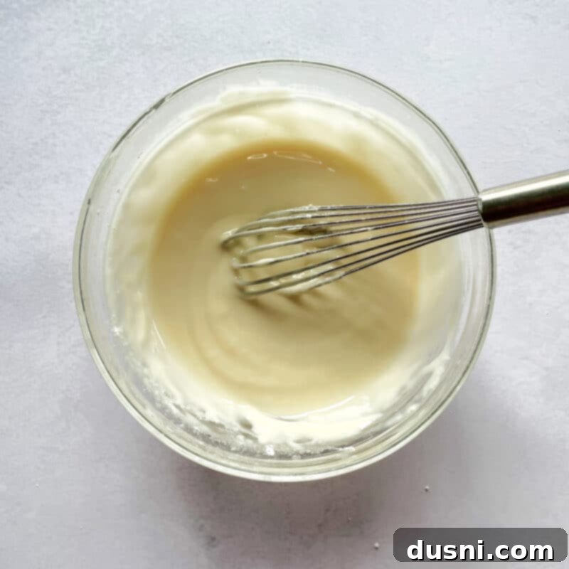 Golden Baked Banana Bites 11 Baked banana fritters arranged on a cooling rack.