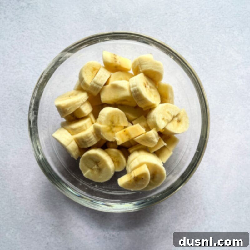 Golden Baked Banana Bites 15 Baked banana fritters with a glass of milk.