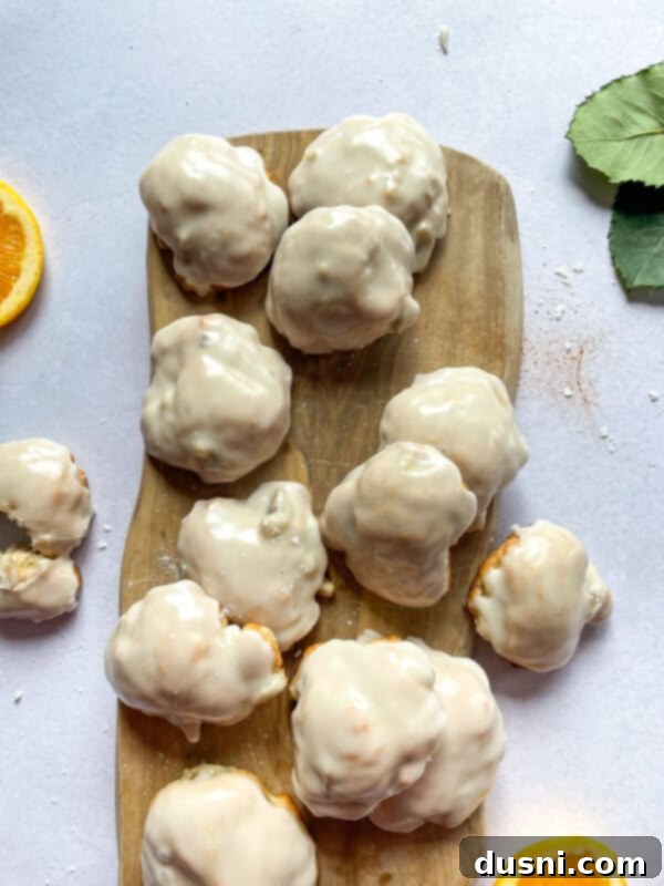 Golden Baked Banana Bites 16 A single baked banana fritter with glaze on a white napkin.