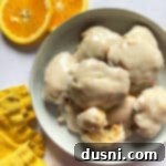 Golden Baked Banana Bites 20 Stacked banana fritters in a white bowl.