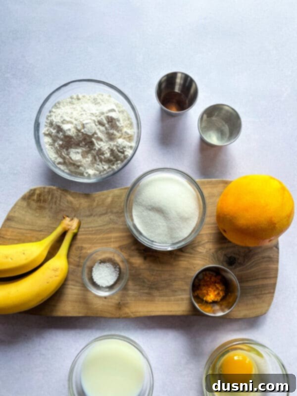 Golden Baked Banana Bites 3 Close-up of baked banana fritters, some glazed, on a white plate with a fork.
