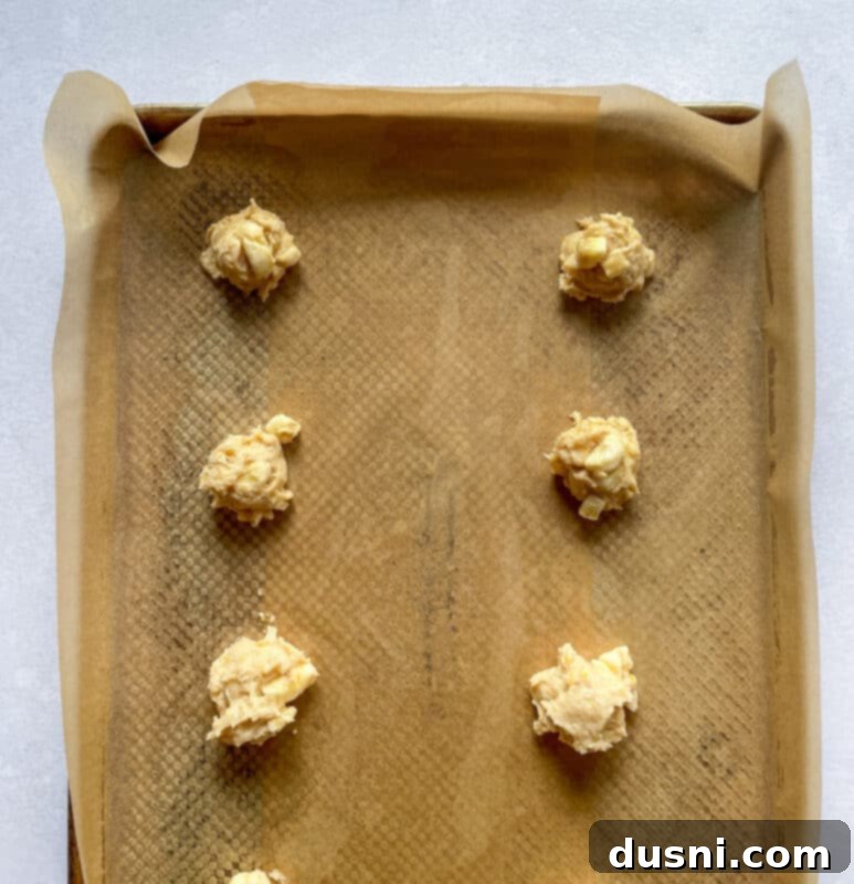 Golden Baked Banana Bites 9 Chopped bananas being folded into the fritter batter in a bowl.