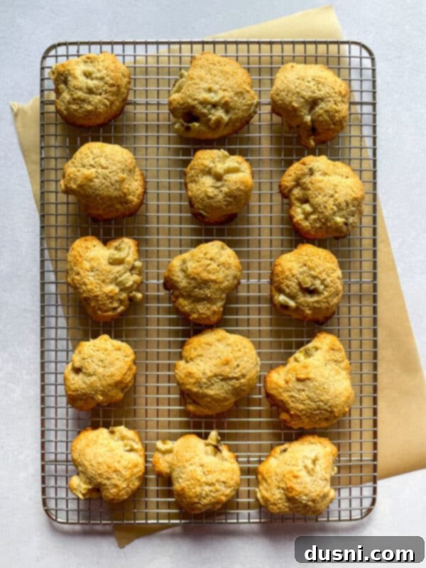 Golden Baked Banana Bites 10 Baked banana fritters cooling on a wire rack.