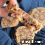 Scotcheroo Swirls 19 Hand holding a Scotcheroo Pinwheel with a bite taken out of it, showing the layered interior