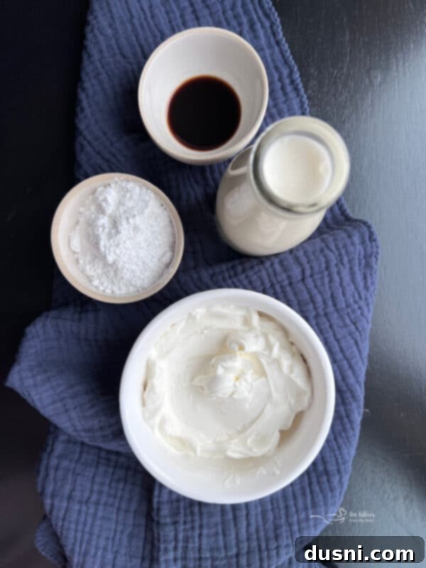 A side view of a blue bowl filled with homemade Devonshire Cream, showcasing its smooth, thick texture, with a serving spoon resting inside.
