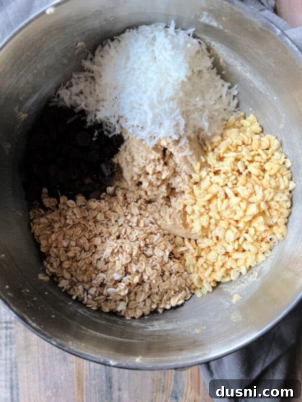 Mom's Homemade Delights 9 Flour mixture being added to the wet ingredients in a mixer bowl.