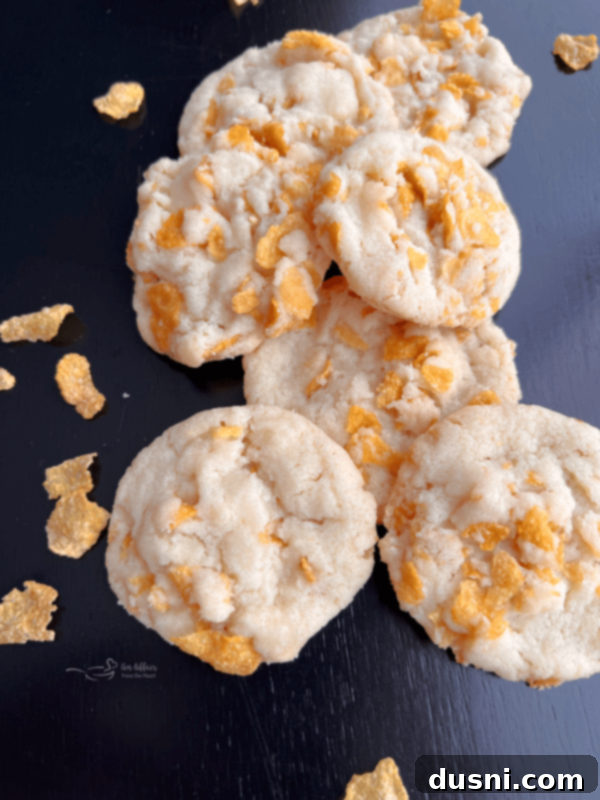 Close-up of golden brown Cornflake Cookies with a crispy texture, stacked on a cooling rack.