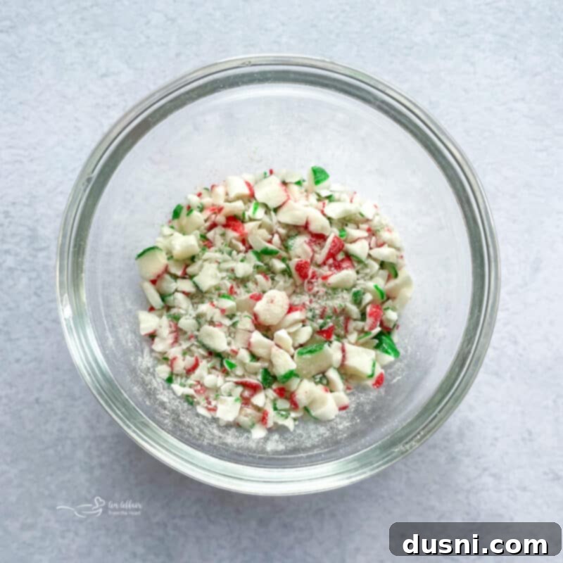Meringue mixture being piped onto a baking sheet, ready for toppings.