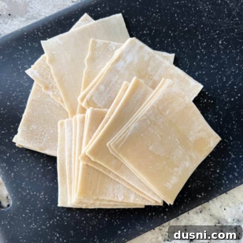 Crispy Air Fryer Wonton Chips 3 Air fryer wonton chips in a white bowl, viewed from above, showcasing their light and crispy texture.