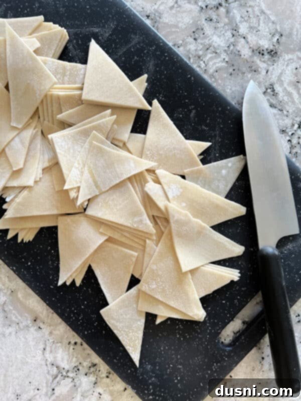 Crispy Air Fryer Wonton Chips 4 Close-up of three simple ingredients: a stack of wonton wrappers, a small bowl of oil, and a pinch of salt.