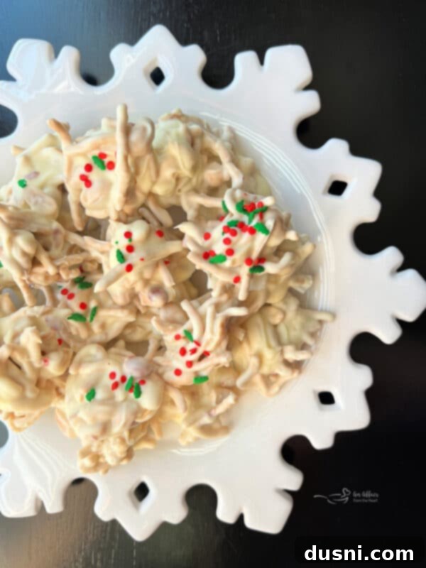 A close-up shot of multiple White Ting A Lings stacked on a dark surface, showcasing their crunchy texture and white coating.