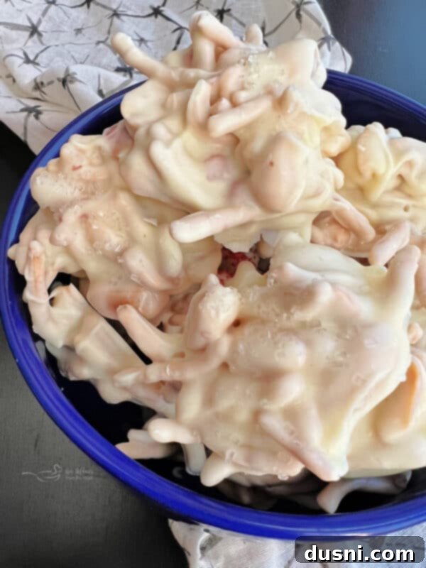 Freshly dropped White Ting A Lings on a parchment-lined baking sheet, waiting to set.