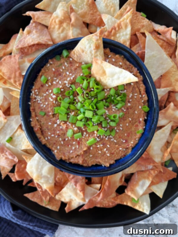 Asian Bean Dip served in a bowl with wonton chips and fresh vegetables