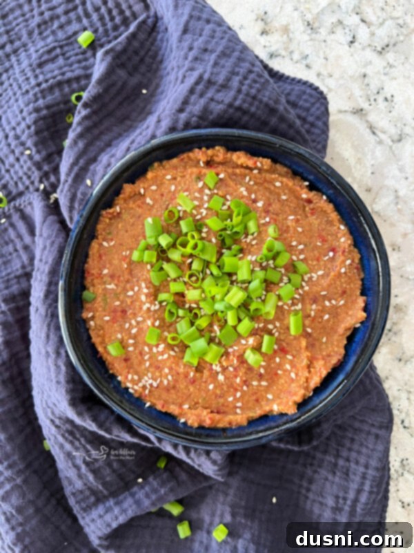 Asian Bean Dip in a blue bowl with dippers, taken from an overhead angle