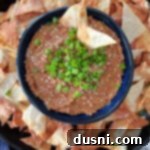 Asian bean dipped topped with green onions in a blue bowl.